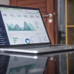 The Tech Stack Behind a Modern WordPress Agency: What We Use at CODE TỐT 1 Laptop with analytics dashboard and code editor representing a modern WordPress agency tech stack