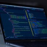 Upgrading from Laravel to WordPress: A Better Web Experience for Content Sites 2 Developer working on code migration project, modern web development workspace with code editor